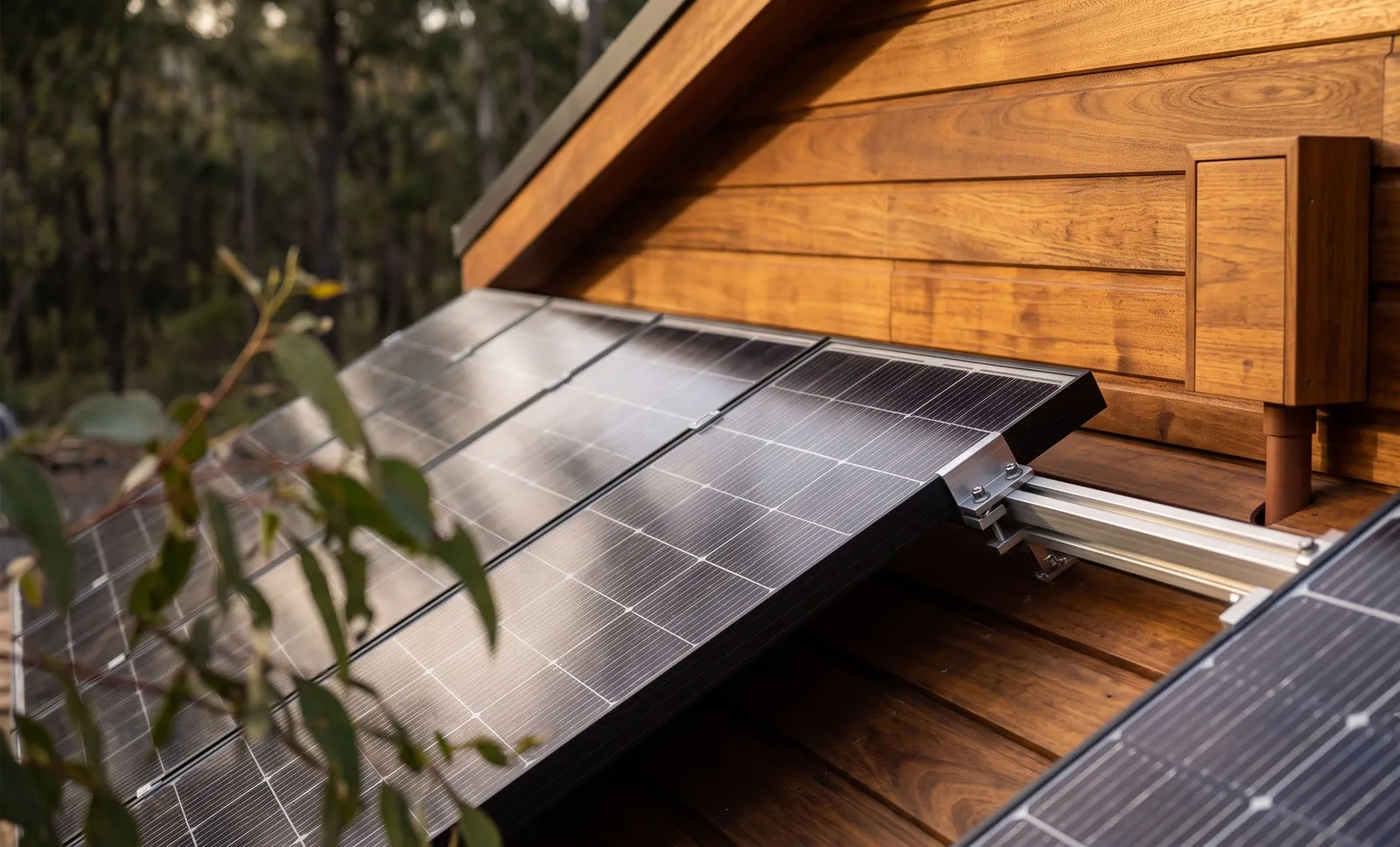 Solar panels on the roof of a timber-clad home in Auckland, New Zealand