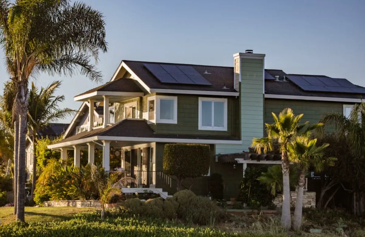 Auckland home with rooftop solar panels at golden hour